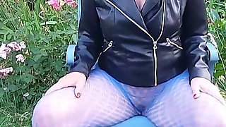 A Mature Woman Is Wearing Sheer Tights Outside.
