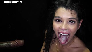 The pretty brunette Harley Haze sucks a big black cock through a gloryhole.