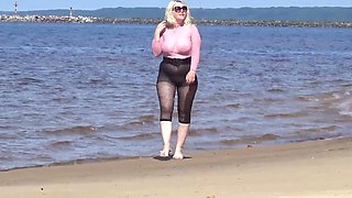 Jokey cougar with nylon caboose and breasts on beach