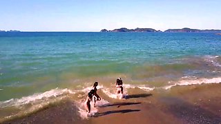 Horny babes masturbating on the beach