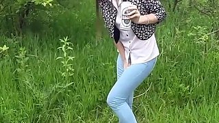 Skinny Brunette with Full Bladder Has to Pee in the Forest and Wet the Tall Grass Touching Her Wet Pussy