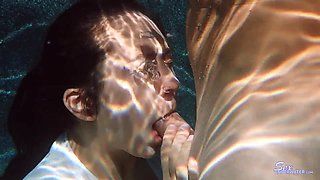 Beautiful coquette fucks under water