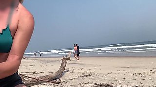 Busty MILF In Green Bikini Handjobs Her Partner On A Public Beach