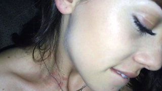 In a kitchen a sexy brunette playing with her big boobs