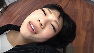 Yuri Sato Asian teen in an office suit gives footjob