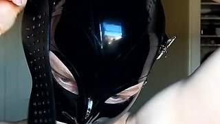 Beautiful amateur BDSM fetishist trying on latex hood mask