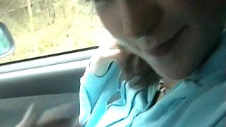 Young brunette gives a blowjob and gets a handjob in a car